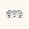 Wide sterling silver ring with three rows of brilliant moissanite stones in geometric pavé setting on white background