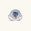 Close-up of sterling silver halo ring with round rainbow moissanite center stone surrounded by baguette-cut stones