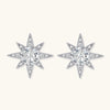 Sterling silver star-shaped stud earrings with brilliant moissanite center stones and pavé details on neutral background.