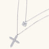 Two delicate sterling silver necklaces with moissanite stones - one solitaire pendant and one cross pendant on white background.
