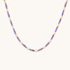 Delicate 18K gold vermeil necklace with alternating lavender zirconia beads and white freshwater pearls on cream background