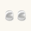 Brushed sterling silver cushion-shaped stud earrings with matte finish on white background