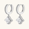 Sterling silver huggie hoops with geometric diamond-shaped moissanite dangles featuring pavé crystal details